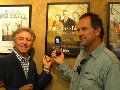 Larry and Rudy Gatlin with the cell phone image of Mother Maybelle Carter's guitar, the same guitar in the poster for our film on the Carter Family.
